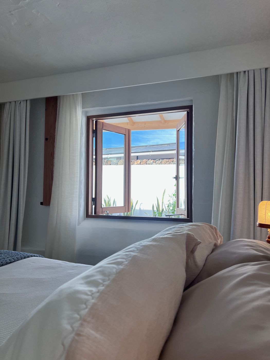 From the bed, the window opens to the courtyard